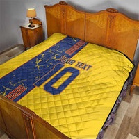 Yellow quilt blanket with blue front panel, custom text and number 10 on bed