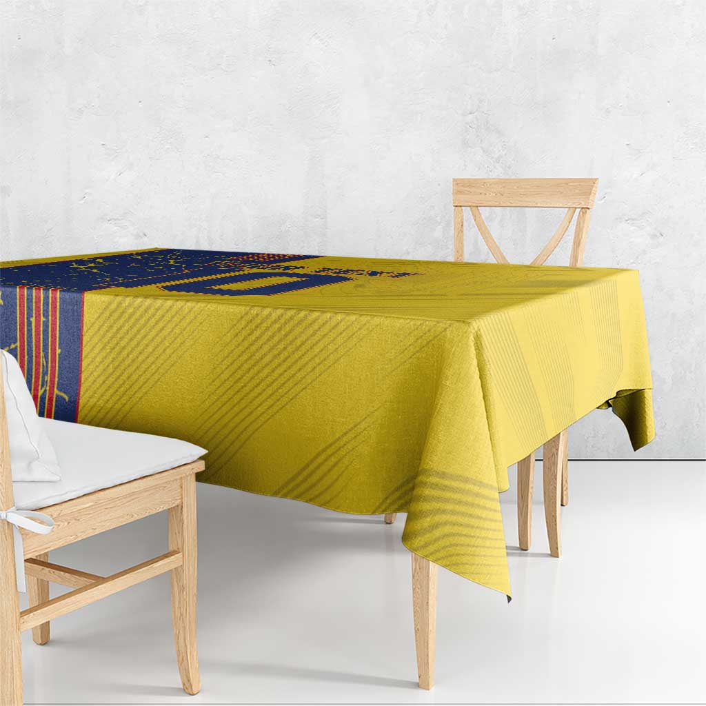 Yellow and blue patterned tablecloth draped over a wooden dining table