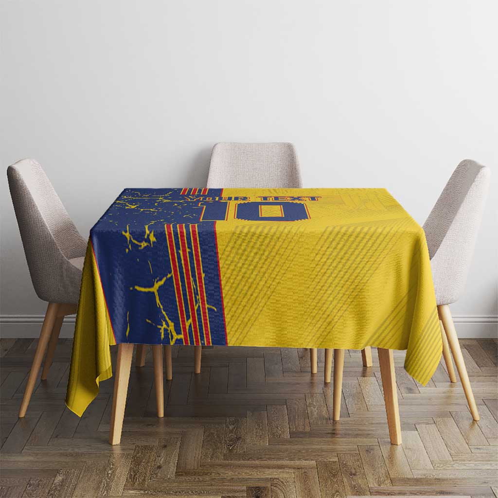 Yellow tablecloth with blue vertical graphic and letter-style design on table