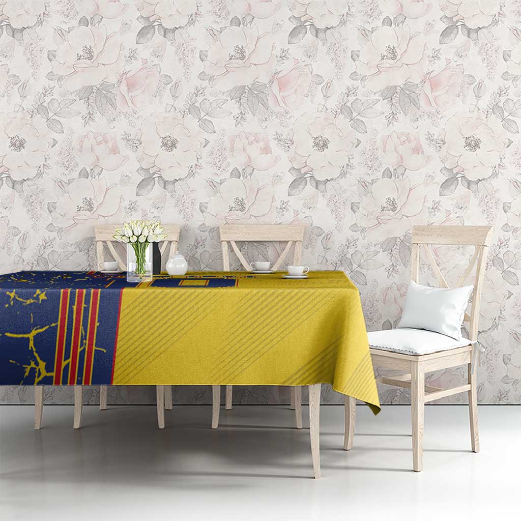Yellow tablecloth with blue motif pattern covering dining table in light room