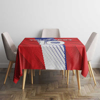 Red football tablecloth with blue-and-white crest and Slovenia outline on dining table.