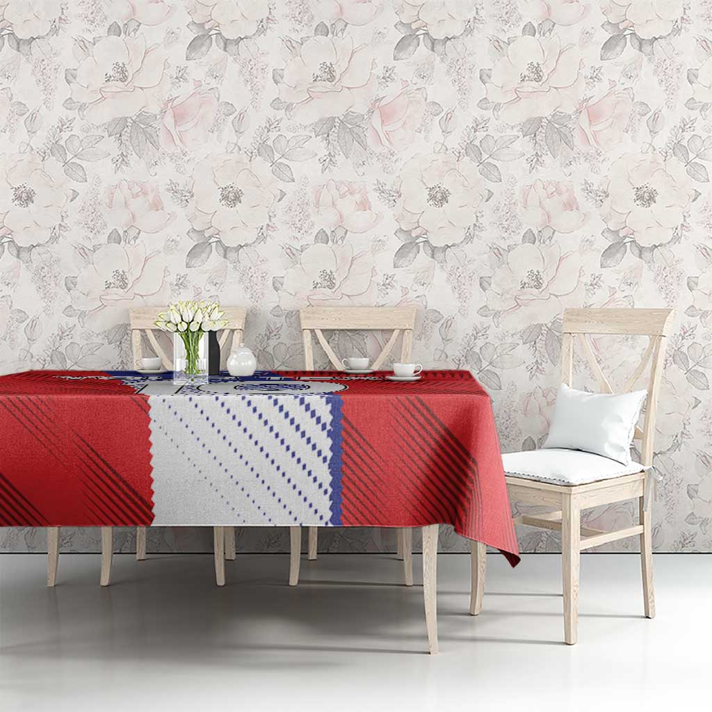 Red custom football tablecloth with blue-and-white Slovenia graphic, laid on dining table.