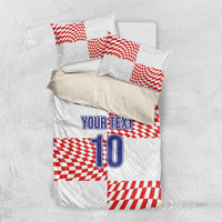 White bedding set with red check accents, “YOUR TEXT” and number “10” on duvet
