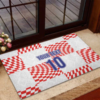 White rubber doormat with red checkered blocks, blue “YOUR TEXT” and number 10