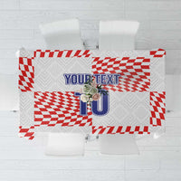 White tablecloth with red checker and stripe football-themed print and custom text area