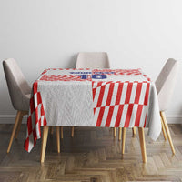 Red-and-white checker tablecloth on dining table with four chairs