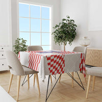 Red-and-white patterned tablecloth on dining table with four chairs