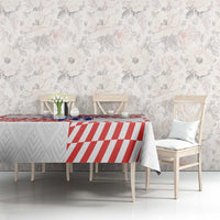 Red-and-white checker tablecloth on table with flowers and decor accessories