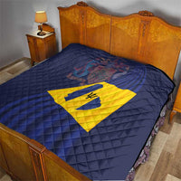 Blue quilted bed blanket with yellow Barbados flag diamond center