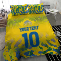 Yellow football bedding set with blue-green camo print, 'YOUR TEXT' and large '10', 2 pillows.