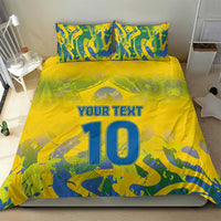 Yellow football bedding set with blue-green camo print, 'YOUR TEXT' and large '10', shown on bed.