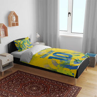 Yellow football bedding set on bed with blue-green camo pattern, 'YOUR TEXT' and large '10'.