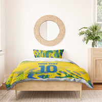 Yellow football bedding set with blue-green camo print, 'YOUR TEXT' and large '10', on bed.