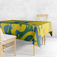 Yellow tablecloth with blue abstract sports pattern draped over dining table