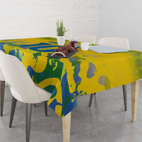 Yellow tablecloth with blue sports design covering dining table with chairs
