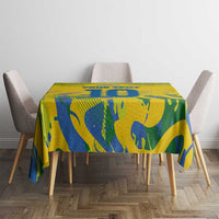 Yellow tablecloth with blue abstract pattern on square table between gray chairs