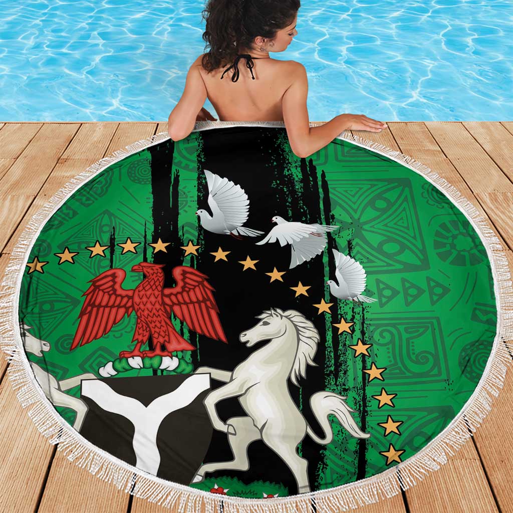 Round beach blanket with white fringe, green-and-black emblem with white dove and horse