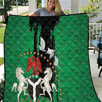 Green quilt with black center showing Nigeria emblem, peace dove, and horses