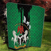 Green and black quilt featuring Nigeria emblem, peace dove, and red lion crest