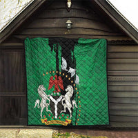Green quilt with black center banner, peace dove and Nigeria crest on display