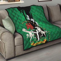 Green quilt on gray sofa showing black center panel, peace dove, and horse emblem