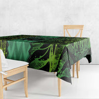 Green football-themed tablecloth with dark graphic accents and patterned center.