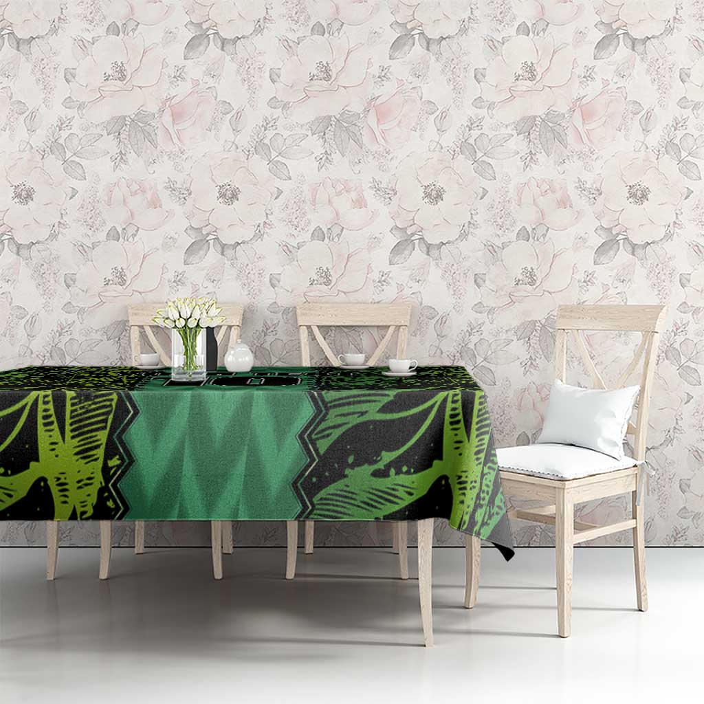 Green football-themed tablecloth with repeating geometric graphics across tabletop.