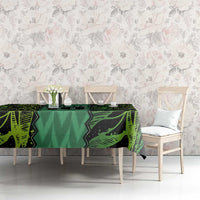 Green football-themed tablecloth with repeating geometric graphics across tabletop.