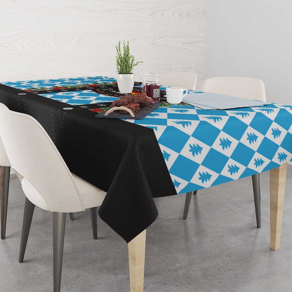 Blue patterned Christmas tablecloth with black edge fabric draped on the sides