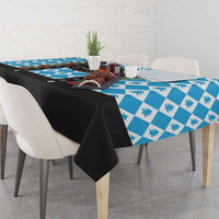 Blue patterned Christmas tablecloth with black edge fabric draped on the sides