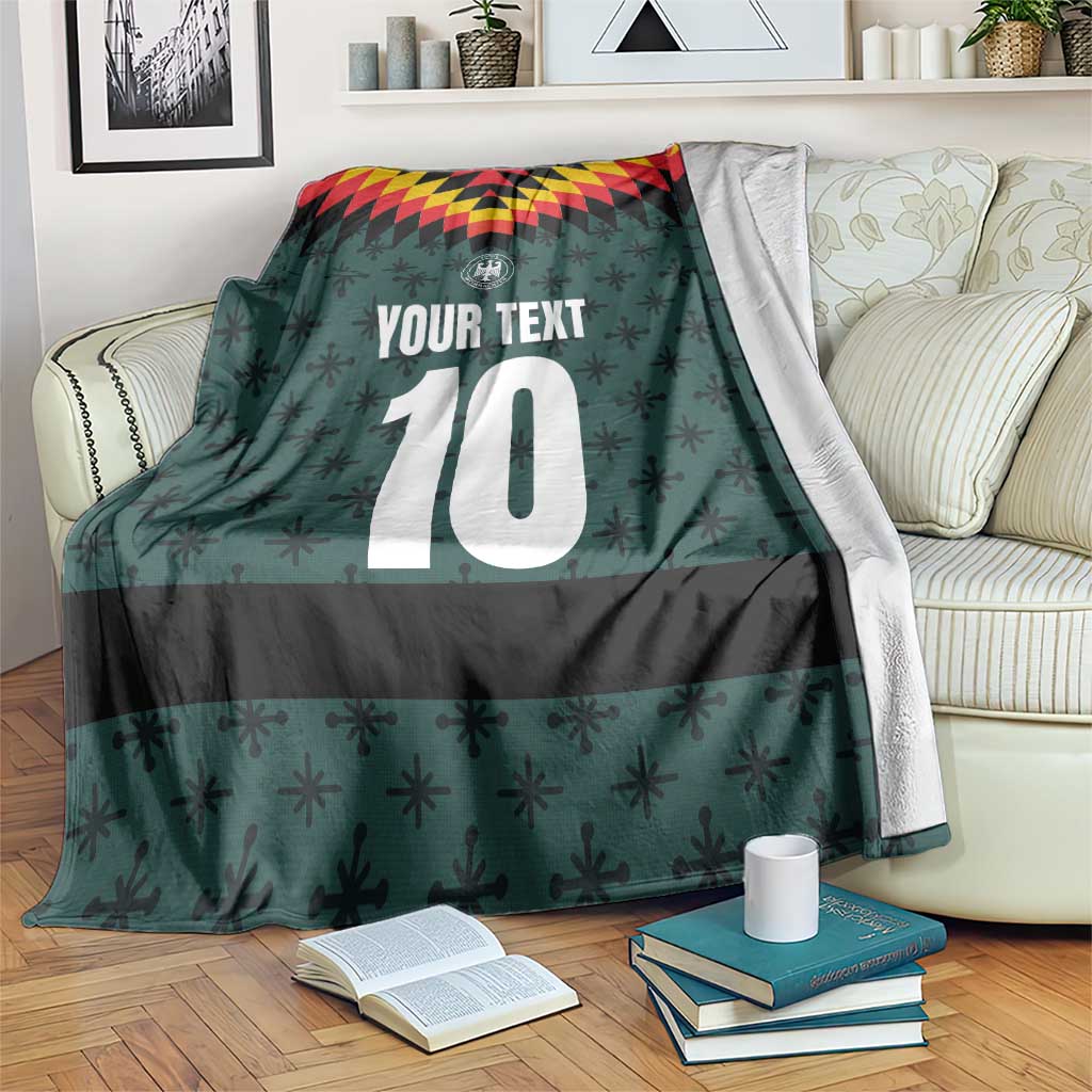 Dark teal sports blanket with custom text and large white number 10, geometric trim