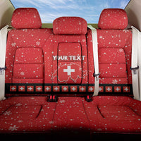 Red car back seat cover: snowflake pattern, Swiss cross badge, and 'YOUR TEXT'.