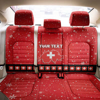 Red car seat back cover with snowflake pattern, Swiss cross emblem, and 'YOUR TEXT'.