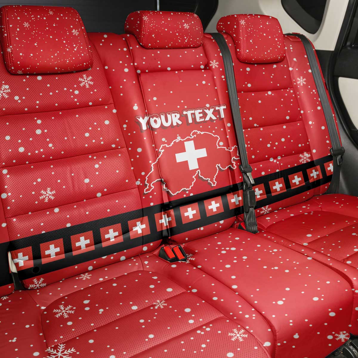 Red car seat back cover set with snowflake dots and Swiss cross badge; 'YOUR TEXT'.