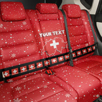 Red car seat back cover set with snowflake dots and Swiss cross badge; 'YOUR TEXT'.