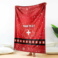 Red personalized blanket with Swiss cross, snowflakes, and dark stripe with plus icons