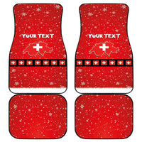 Set of four red car mats with snowflakes, Swiss cross pattern, and 'YOUR TEXT'
