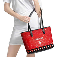 Red leather tote with black handles and trim, "YOUR TEXT" and Swiss map graphic