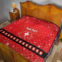 Red bed quilt with Swiss cross, “YOUR TEXT”, and white striped border