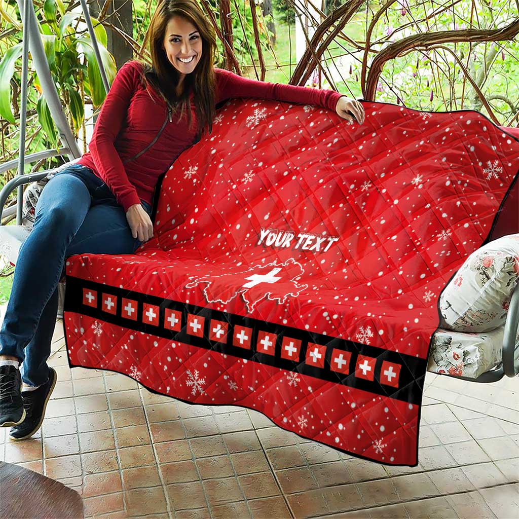 Red quilt with Swiss cross and “YOUR TEXT”, held on patio