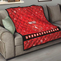 Red quilt with Swiss cross and “YOUR TEXT”, draped over sofa