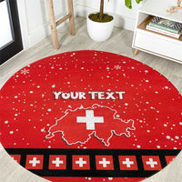 Red round Christmas rug with white snowflake dots, Swiss cross map and black border accents.