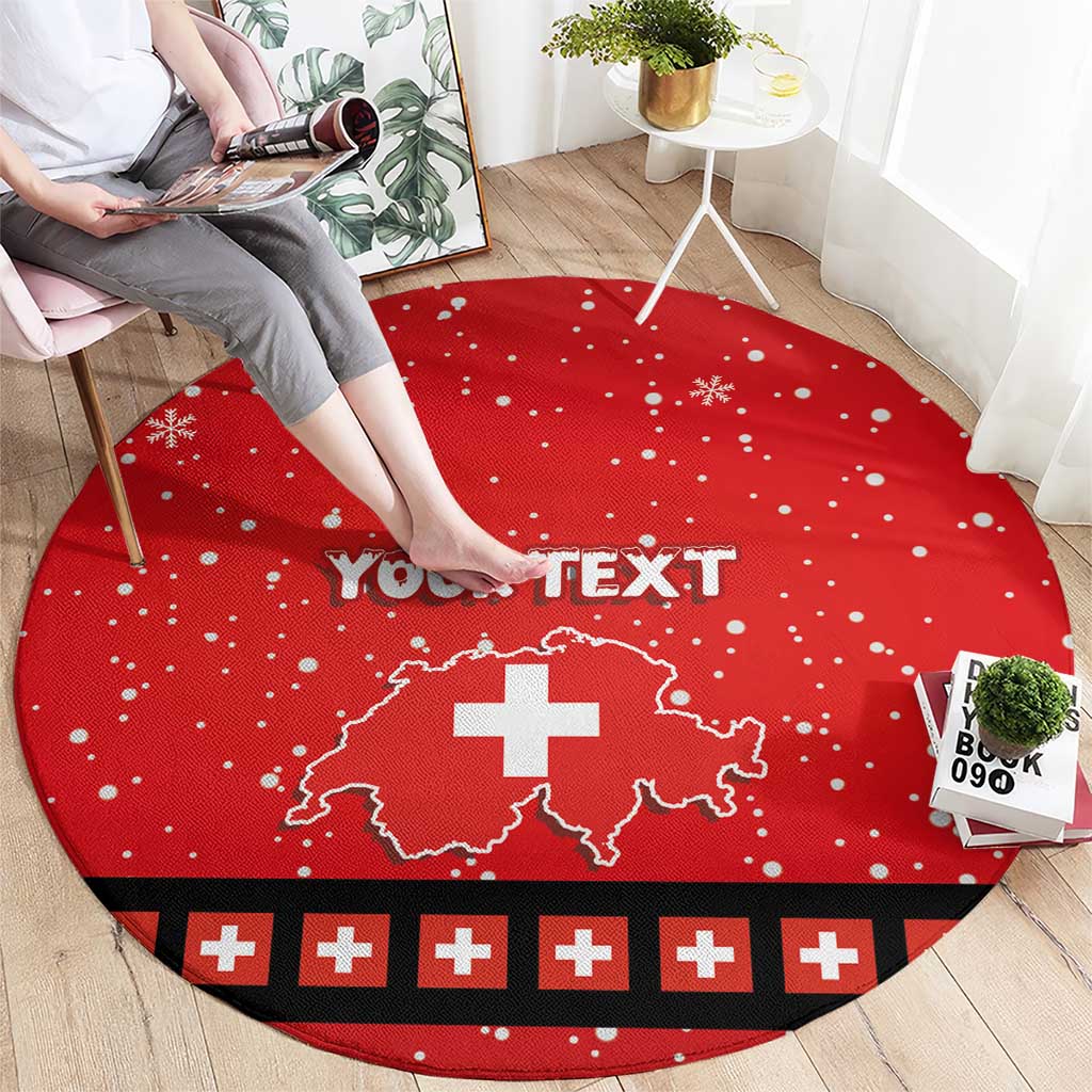 Red round Christmas area rug with white snowflake dots, Swiss cross map and black patterned edge.