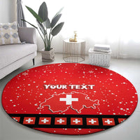 Red round Christmas rug featuring white snowflake dots, Swiss cross map, and black stripe border.