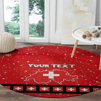 Red round Christmas floor rug with white snowflake dots, Swiss cross map, and black border stripes.
