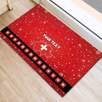 Red rubber doormat rug with “YOUR TEXT” and Swiss map-and-cross design, snowflake speckles