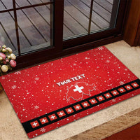 Red rubber doormat featuring “YOUR TEXT,” Swiss map with cross, snowflakes, black-and-red border
