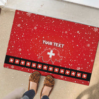 Red personalized rubber doormat with “YOUR TEXT,” Swiss cross map, snowflakes, black patterned stripe