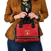 Red festive handbag with black top handles and front “YOUR TEXT” plus Swiss cross.