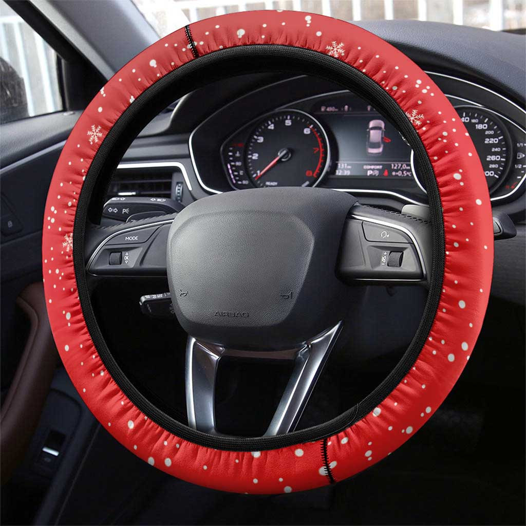 Red steering wheel cover with black edge and white snowflake dot pattern on the rim